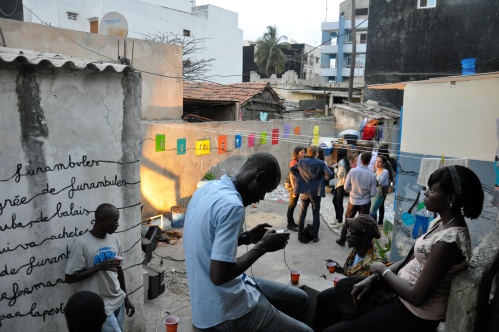 Mel-odile and Theirno Seydou Sall's collaborative installation for Saxalart blends painting and poetry with laundry and electric lines, chez Babacar Diouf Rafet. Image (c) Babacar Traoré Doli